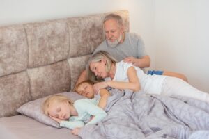 grandparents laying in bed watching kids sleep, grandparents raising grandkids